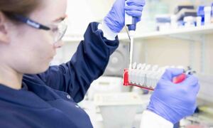 Female scientist pipetting
